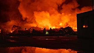 Firefighters put out a fire after Russian missiles hit a warehouse in Kyiv, 5 August, 2026