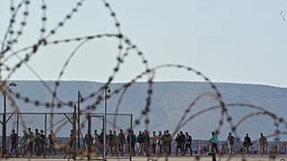 Migrants rescued south of Crete walk after their arrival at the the port of Lavrio, Greece, on July 10, 2025