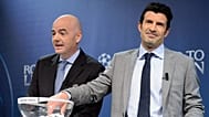Former Portuguese footballer Luis Figo, right, choses a ball next to Gianni Infantino, left, during a Champions League draw in 2014.