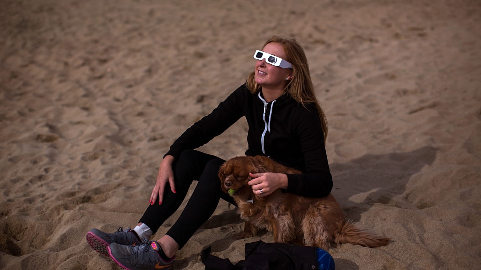 A woman watches Spain's last solar eclipse in 2015