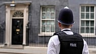 A police officer stands opposite the door of 10 Downing Street in London, Tuesday, April 12, 2022.