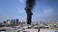 تصاعد دخان أسود من مستودع في المنطقة الصناعية بمدينة الشارقة في الإمارات، عقب تقارير عن ضربات إيرانية استهدفت دبي، 1 آذار 2026.