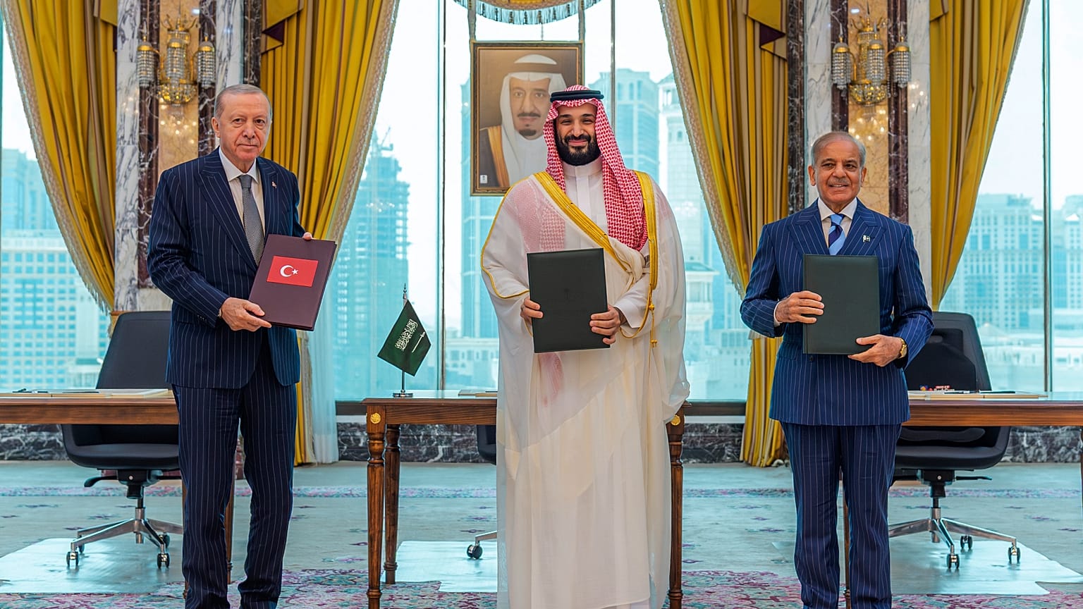 From left, Turkish Recep Tayyip Erdogan, Saudi Crown Prince Mohammed bin Salman and Pakistani PM Shehbaz Sharif pose after signing a trilateral defense in Mecca, Saudi Arabia.