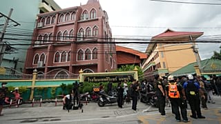 People gather outside after a shooting at the Debsirin Nonthaburi School in Thailand's Nonthaburi province, 7 August, 2026