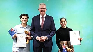 Fatemeh Pasandideh, left, and Atefeh Ramezanisadeh with Australia's Minister for Home Affairs Tony Burke in Brisbane, 5 August, 2026