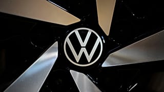 The logo of German car manufacturer Volkswagen is pictured at Volkswagen's transparent factory in Dresden, Germany, on May 14, 2025. 