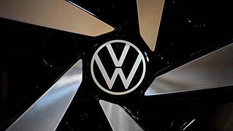 The logo of German car manufacturer Volkswagen is pictured at Volkswagen's transparent factory in Dresden, Germany, on May 14, 2025. 