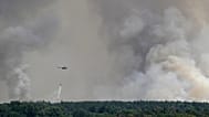 A Serbian Army helicopter battles a fire in Deliblatska Pescara (Deliblato Sands), near the village of Sumarak, 70 kilometers north-west of Belgrade, Serbia, Aug. 7, 2026.