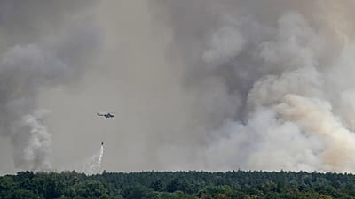 A Serbian Army helicopter battles a fire in Deliblatska Pescara (Deliblato Sands), near the village of Sumarak, 70 kilometers north-west of Belgrade, Serbia, Aug. 7, 2026.
