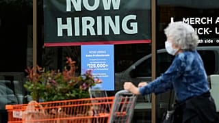 Hiring sign for sales professionals is displayed at a store, in Vernon Hills, Ill., Wednesday, April 15, 2026.