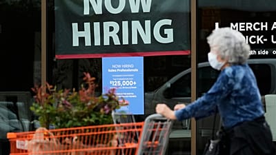 Hiring sign for sales professionals is displayed at a store, in Vernon Hills, Ill., Wednesday, April 15, 2026.