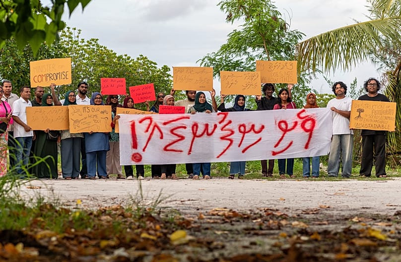 Members of Project ThimaaVeshi, team up with Veshi Saafu, a group of older women, to demonstrate against reclamation projects in Addu City, Maldives, June 5, 2026. 