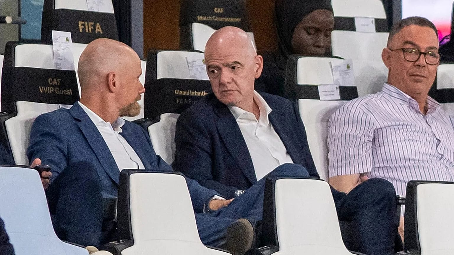 FIFA president Gianni Infantino, center, speaks to FIFA secretary general Mattias Grafstrom, left, sitting beside president of Moroccan Royal Football Federation Fouzi Lekjaa.