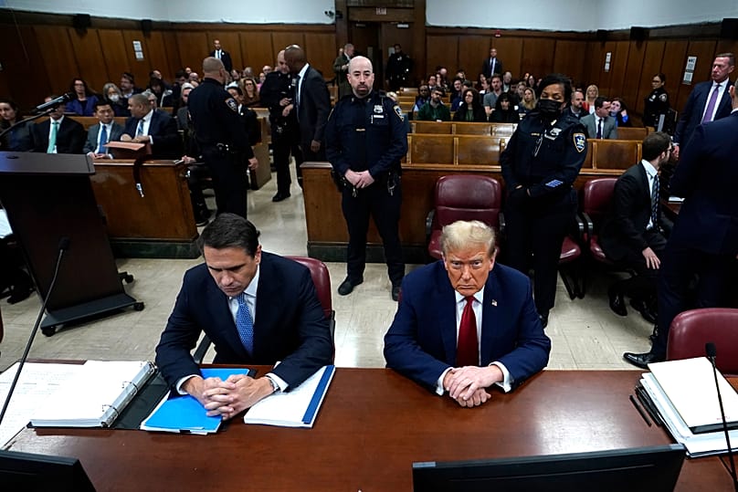 US President Donald Trump sitting next to lawyer Todd Blanche, attends his trial for covering up hush money payments linked to extramarital affairs, 23 April 2024.