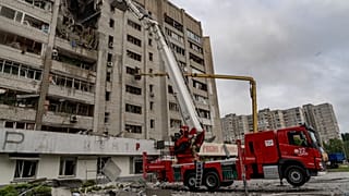 Firefighters put out a fire after a residential building was hit following Russia's drone attack in Kharkiv, Ukraine, Sunday, Aug. 9, 2026