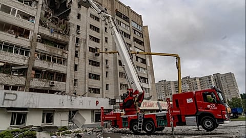Firefighters put out a fire after a residential building was hit following Russia's drone attack in Kharkiv, Ukraine, Sunday, Aug. 9, 2026