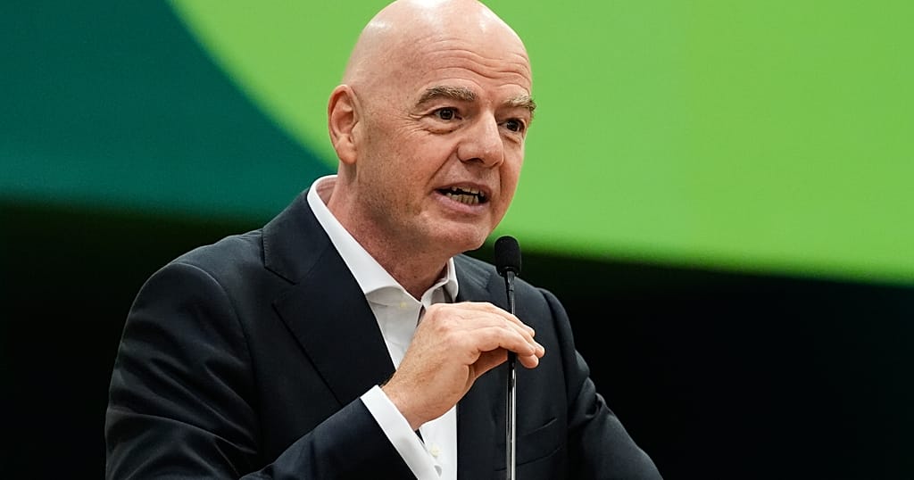 A man in a suit speaking at a podium.
