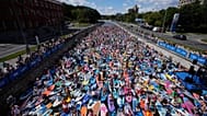 People steer their stand-up paddle (SUP) boards during the costumed SUP surfing festival along the Yauza river in Moscow,