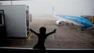 A child watches a plane at the Jorge Newbery airport in Buenos Aires