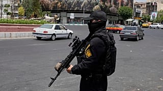 FILE: A member of Iran's IRGC stands guard at Enqelab-e-Eslami square in downtown Tehran, 24 June 2025