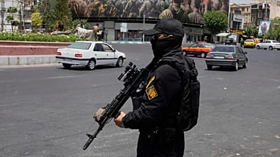 FILE: A member of Iran's IRGC stands guard at Enqelab-e-Eslami square in downtown Tehran, 24 June 2025