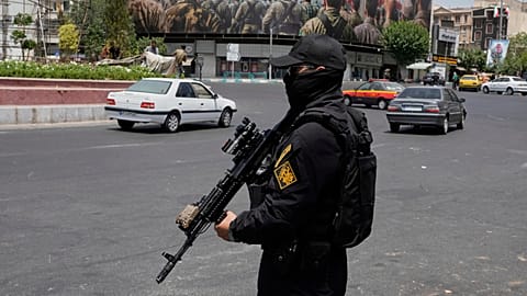 FILE: A member of Iran's IRGC stands guard at Enqelab-e-Eslami square in downtown Tehran, 24 June 2025