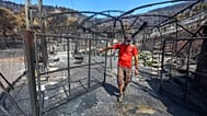 Un hombre inspecciona los daños que ha ocasionado el fuego a su propiedad