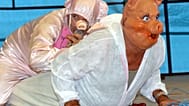 FILE: Contestants in the French Pig-Squealing Championships perform during the annual Pig festival in Trie-sur-Baise