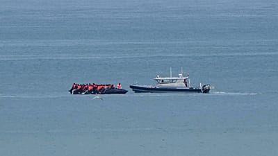 A boat thought to carry migrants is escorted by a vessel from the French Gendarmerie Nationale in the English Channel off Wimereux beach, 4 September, 2024