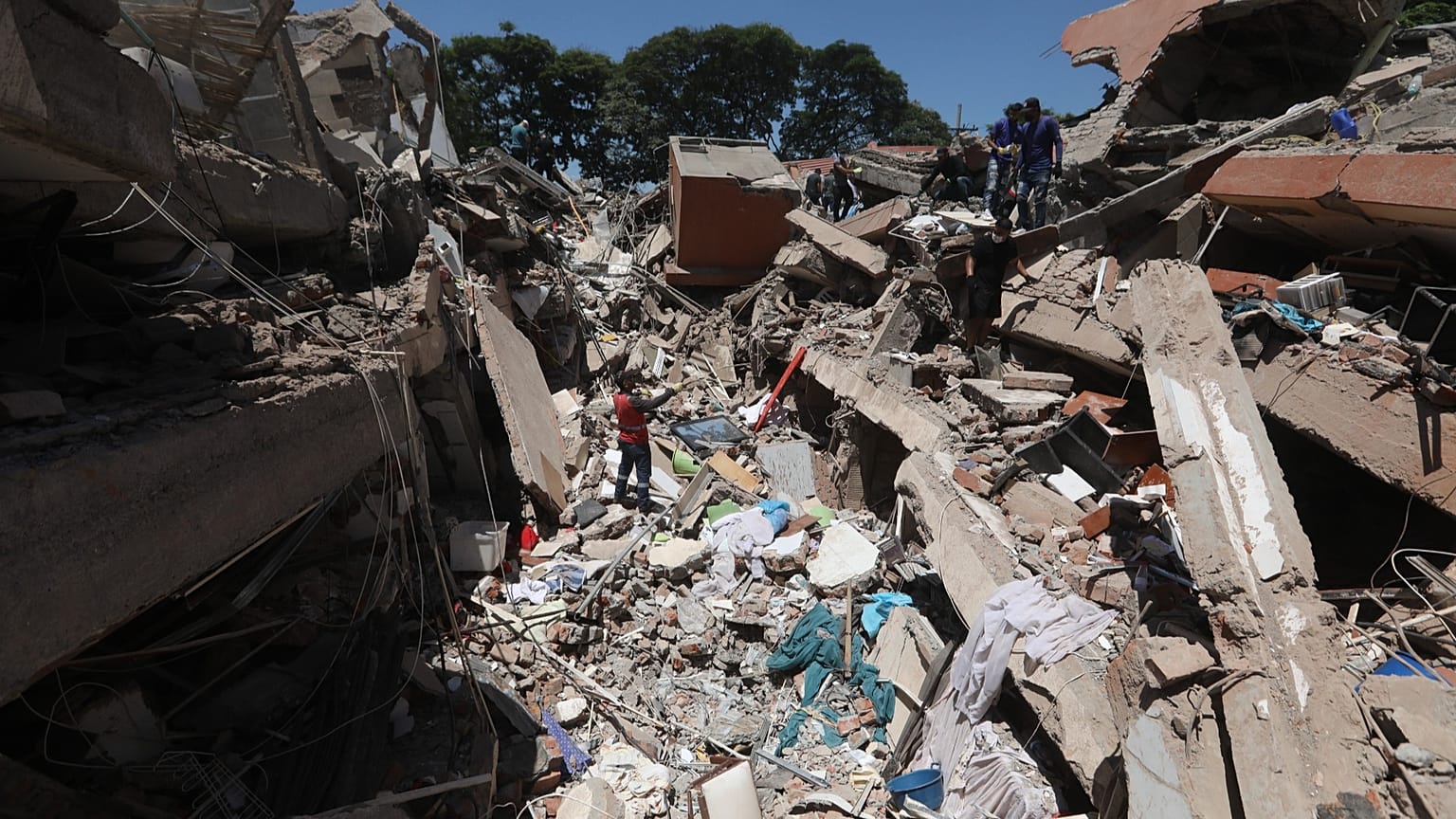 Residents and rescue workers search through the rubble of a collapsed building after an earthquake struck Cali, 10 August, 2026