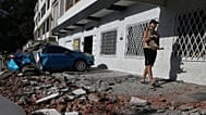 A man carries his dog after an earthquake struck Cali, 10 August, 2026