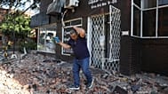A man leaves an apartment building after an earthquake struck Cali, 10 August, 2026