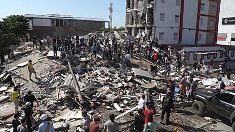 Residents and rescue workers search through the rubble of a collapsed building after an earthquake struck Cali, 10 August, 2026