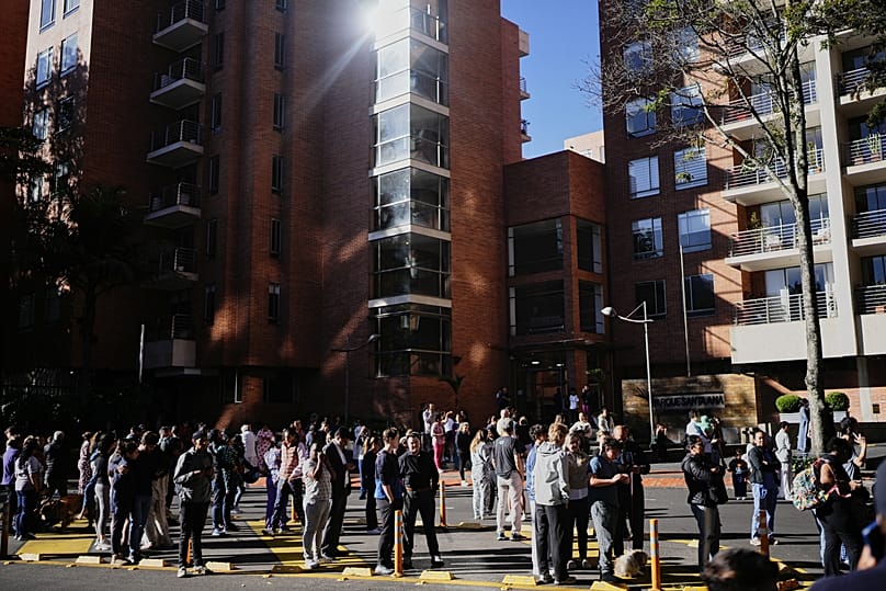 People stand outside their homes after a quake was felt in Bogotá, 10 August, 2026