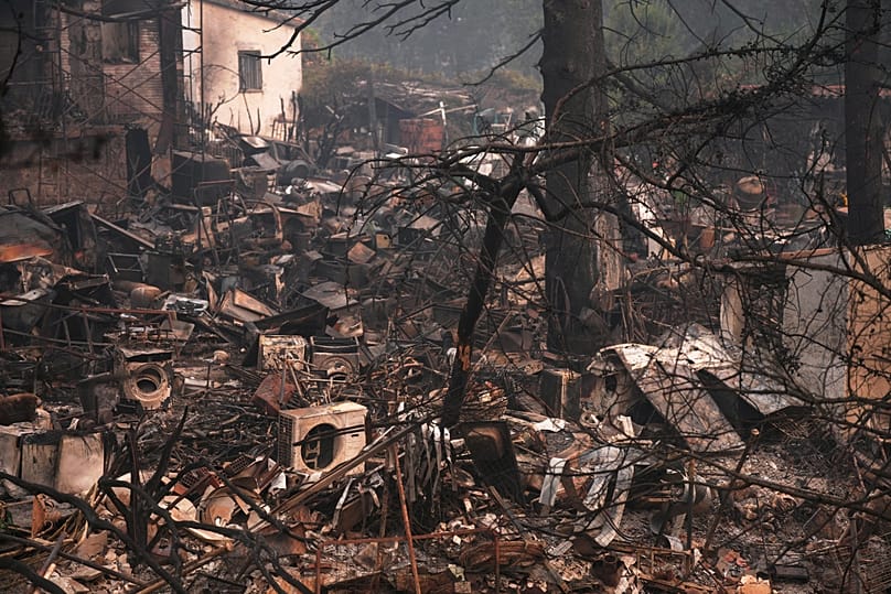 A house and belongings destroyed by a wildfire are photographed as the fire continues to spread near Pelayos de la Presa, 28 July, 2026
