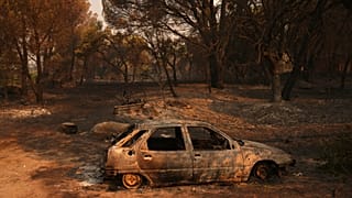 A car burned by a wildfire sits in Piedralaves, 28 July, 2026