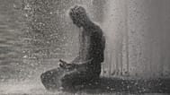 A person cools off at Trocadero fountain near the Eiffel Tower during a heat wave in Paris, 24 June, 2026