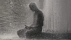 A person cools off at Trocadero fountain near the Eiffel Tower during a heat wave in Paris, 24 June, 2026