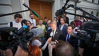 Journalists and supporters of the Yabloko party listen to party leader Nikolai Rybakov at the Russia's Supreme Court, in Moscow, 10 August 2026