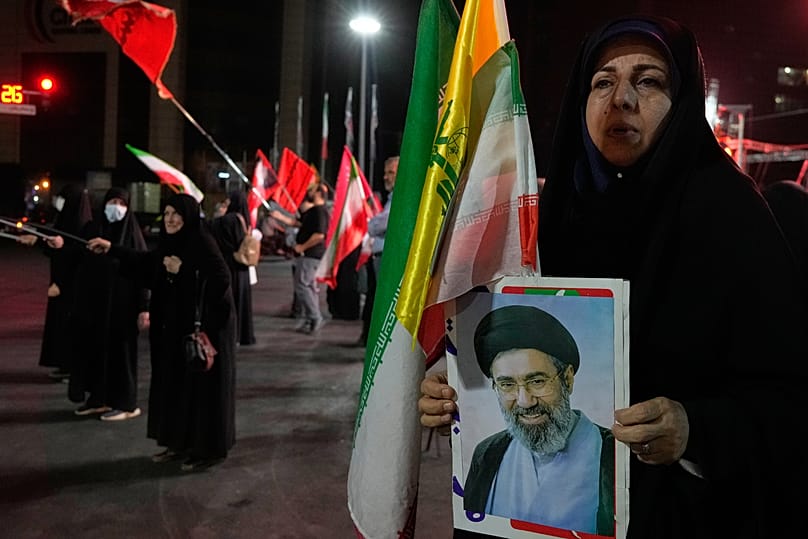 An Iranian pro-government demonstrator holds a poster of the Supreme Leader Ayatollah Mojtaba Khamenei in Tehran, 28 July, 2026