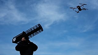 A police officer poses with an anti-drone signal jammer during after the opening ceremony of a Drone Competence and Defence centre in Erding, 4 May, 2026