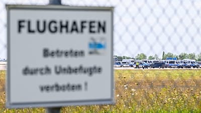 Police vehicles are parked along the north runway at Leipzig/Halle Airport, 6 August, 2026 