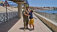 A 12-year-old unaccompanied minor who crossed into Spain is escorted by a Spanish soldier