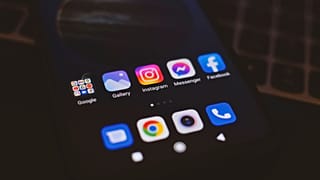 A smartphone screen displaying popular social media icons against a black background. 