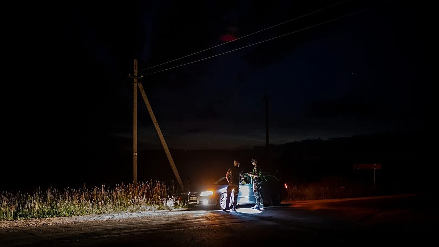 In this file photo taken on Saturday, July 10, 2021, Members of the Lithuania State Border Guard Service check vehicle as they patrol on the border with Belarus.