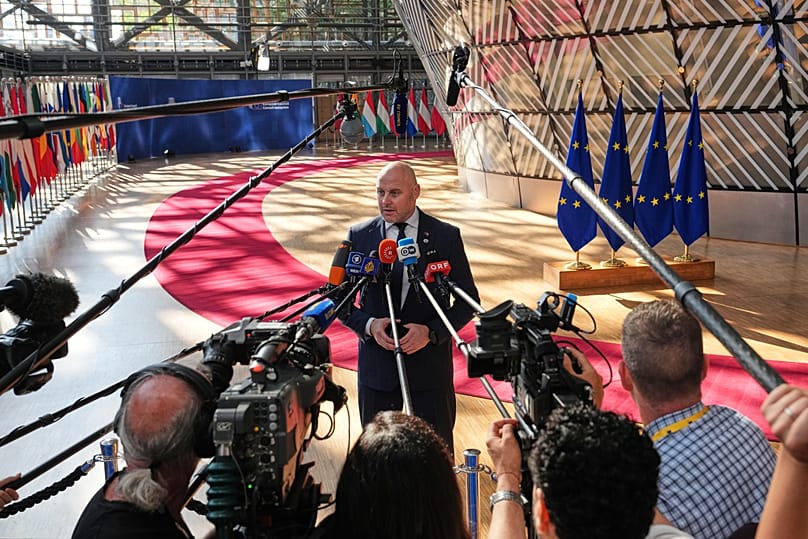 Latvia's Prime Minister Andris Kulbergs talks to journalists as he arrives for the EU summit in Brussels, 19 June, 2026