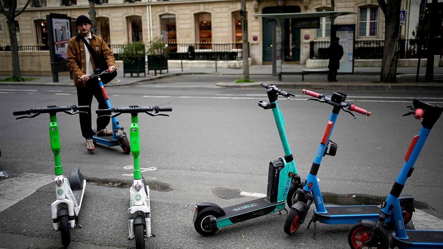 A man parks a scooter in Paris, Friday, march 31, 2023