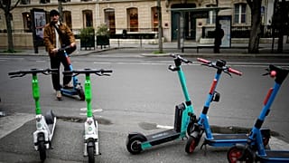 A man parks a scooter in Paris, Friday, march 31, 2023