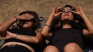 Several people lie on the ground to watch the total solar eclipse at UNAM University in Mexico City, Monday 8 April 2024. (AP Photo/Marco Ugarte)
