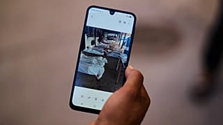 A Ceuta resident shows a photo of body bags containing migrants who died while trying to cross into the Spanish enclave of Ceuta from Morocco, Tuesday, Aug. 4, 2026.